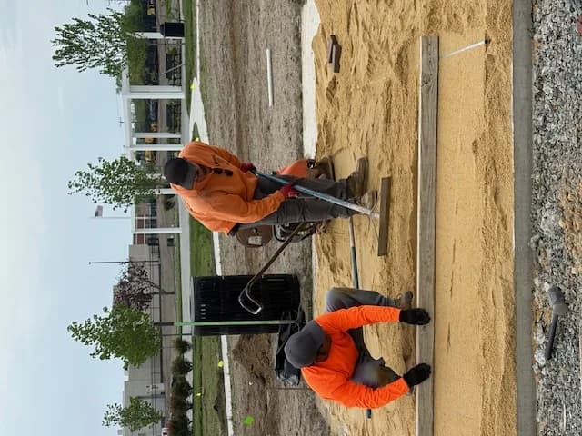Crew screeding a compacted base for a paver patio in Galloway, NJ