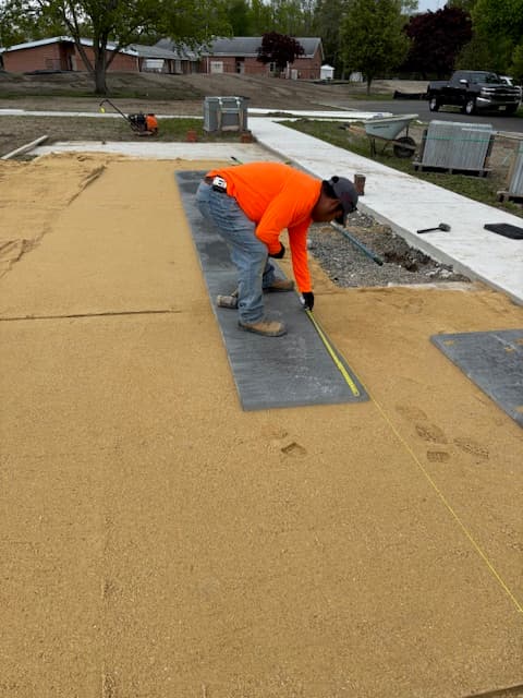 T.W. Outdoor Services crew member setting the first course of pavers in Galloway, NJ