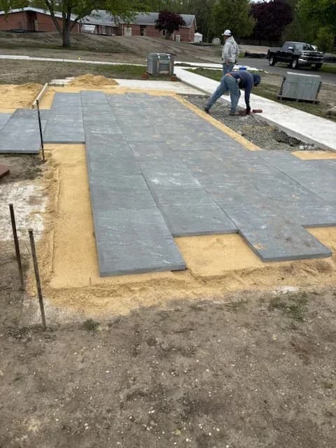 Charcoal running-bond paver patio mostly installed in a Galloway, NJ yard