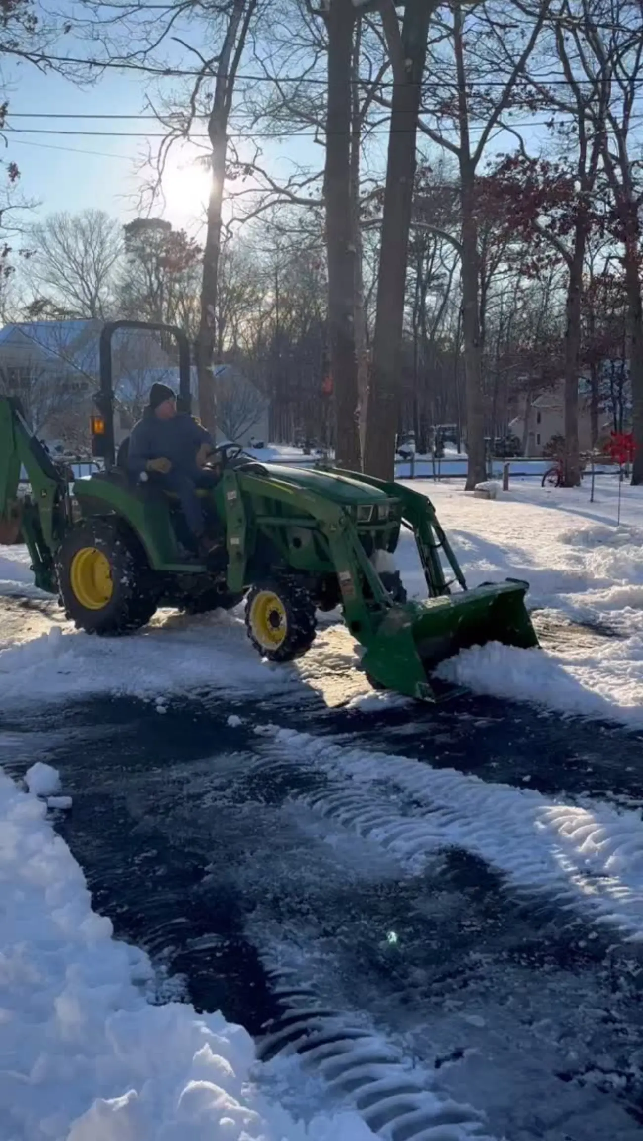 T.W. Outdoor Services clearing a snowy driveway with a tractor plow in South Jersey